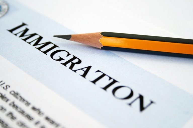 An immigration form and a pencil